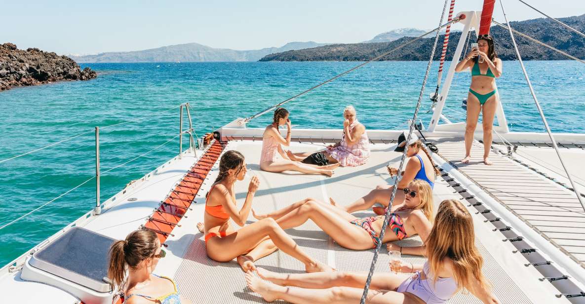Santorini: Catamaran Tour With BBQ Dinner, Drinks, and Music - Inclusions and Host